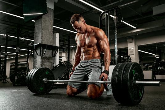 A strong fit man lifting heavy weights thinking about a massage chair